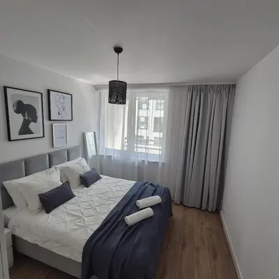 Łóżko lub łóżka w pokoju w obiekcie Apartament Near Sky Tower