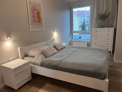 Łóżko lub łóżka w pokoju w obiekcie Złote Apartamenty 36