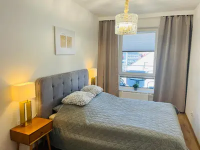 Łóżko lub łóżka w pokoju w obiekcie Złote Apartamenty 58