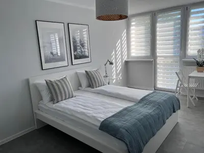 Łóżko lub łóżka w pokoju w obiekcie APARTAMENT OŚ. JASNE 9C