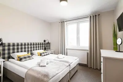 Łóżko lub łóżka w pokoju w obiekcie Róża Sudetów Apartamenty