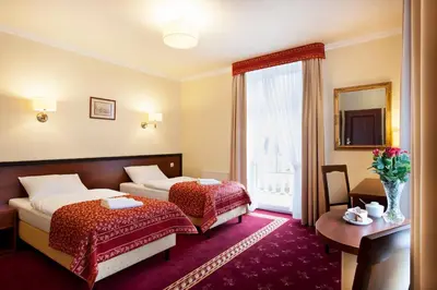Łóżko lub łóżka w pokoju w obiekcie Resort de Esperanto Sanatorium Uzdrowiskowe