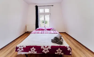 Łóżko lub łóżka w pokoju w obiekcie Domki Nad Stawami Apartament