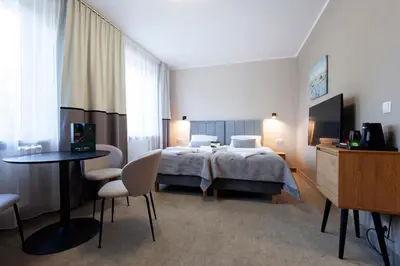 Łóżko lub łóżka w pokoju w obiekcie Holimo Hotel
