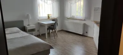 Łóżko lub łóżka w pokoju w obiekcie Apartamenty Pod Lasem