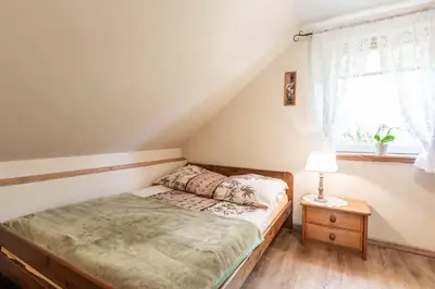 Łóżko lub łóżka w pokoju w obiekcie Domek pod Orzechem