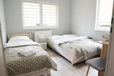 Łóżko lub łóżka w pokoju w obiekcie Apartamenty Zdrój