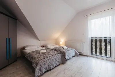 Łóżko lub łóżka w pokoju w obiekcie Dom Zakątek, Kudowa Zdrój