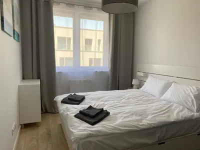 Łóżko lub łóżka w pokoju w obiekcie Gdańska Duo