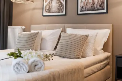 Łóżko lub łóżka w pokoju w obiekcie Apartment Wrocław Braniborska by Noclegi Renters