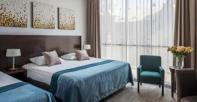 Łóżko lub łóżka w pokoju w obiekcie Europeum Hotel