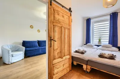 Łóżko lub łóżka w pokoju w obiekcie Apartament Pod Jałowcem Góry Sowie 533-543-732