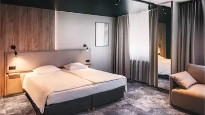 Łóżko lub łóżka w pokoju w obiekcie Qubus Hotel Legnica