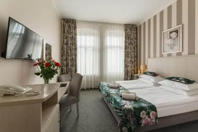 Łóżko lub łóżka w pokoju w obiekcie Hotel Amalia