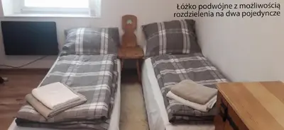 Łóżko lub łóżka w pokoju w obiekcie Apartament Alpejski Duży