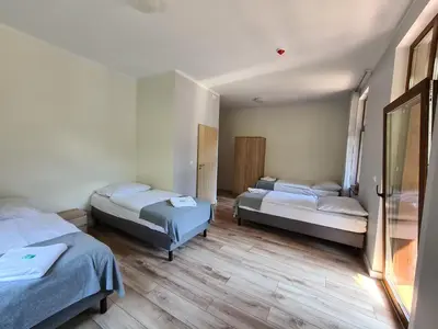 Łóżko lub łóżka w pokoju w obiekcie Willa Góralka