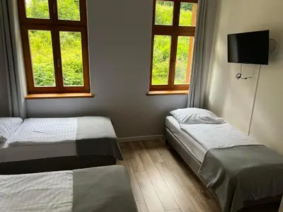 Łóżko lub łóżka w pokoju w obiekcie Willa Góralka