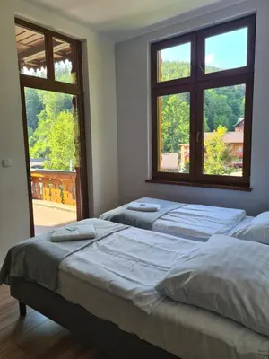 Łóżko lub łóżka w pokoju w obiekcie Willa Góralka