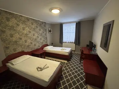 Łóżko lub łóżka w pokoju w obiekcie Hotel Ava