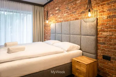 Łóżko lub łóżka w pokoju w obiekcie Ogrody Pieniawskie, MyWeek