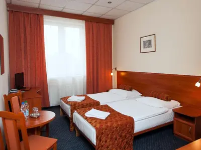 Łóżko lub łóżka w pokoju w obiekcie Hotel Arkadia