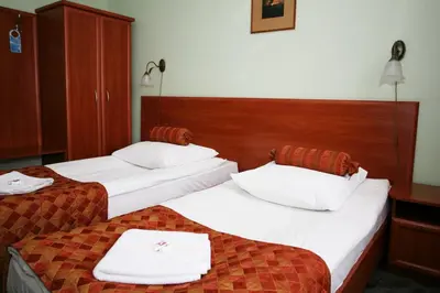 Łóżko lub łóżka w pokoju w obiekcie Hotel Arkadia