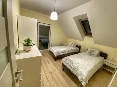 Łóżko lub łóżka w pokoju w obiekcie Apartamenty Eksploris II