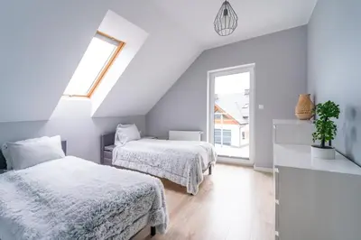 Łóżko lub łóżka w pokoju w obiekcie Apartamenty Eksploris II