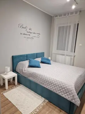 Łóżko lub łóżka w pokoju w obiekcie Apartament na Letniej z garażem 