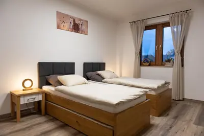 Łóżko lub łóżka w pokoju w obiekcie Apartament Nad Stajnią