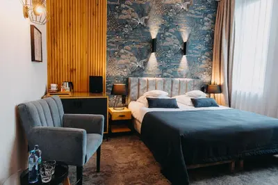 Łóżko lub łóżka w pokoju w obiekcie Hotel Szara Willa