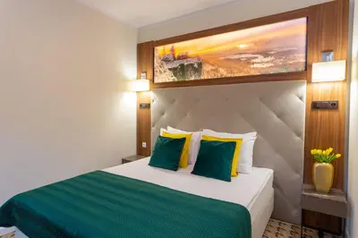 Łóżko lub łóżka w pokoju w obiekcie Hotel Verde Montana Wellness & Spa