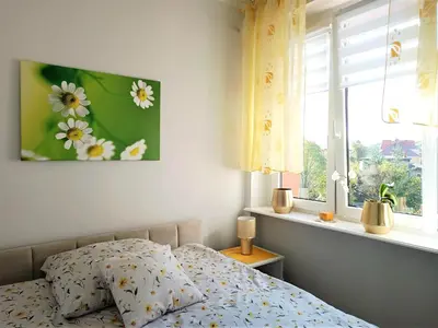 Łóżko lub łóżka w pokoju w obiekcie Szmaragdowy apartament przy ulicy Opolskiej