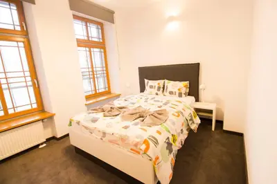 Łóżko lub łóżka w pokoju w obiekcie Happy Estate Apartments - Trakt Kupiecki