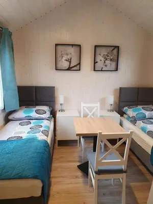 Łóżko lub łóżka w pokoju w obiekcie Pokoje Babie Lato