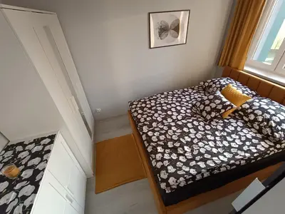 Łóżko lub łóżka w pokoju w obiekcie Bursztynowy Apartament
