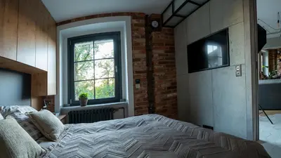 Łóżko lub łóżka w pokoju w obiekcie Industrial Apartment 