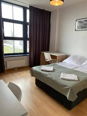 Łóżko lub łóżka w pokoju w obiekcie SleepWell Apartments