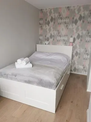 Łóżko lub łóżka w pokoju w obiekcie Apartament Manhattan