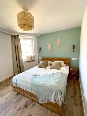 Łóżko lub łóżka w pokoju w obiekcie Sosnowy Apartament