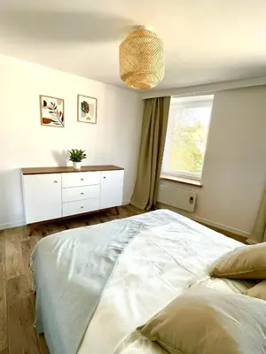 Łóżko lub łóżka w pokoju w obiekcie Sosnowy Apartament
