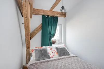 Łóżko lub łóżka w pokoju w obiekcie Apartament Mikołowska