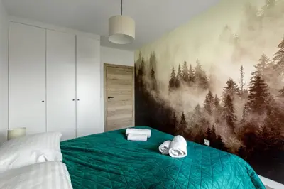 Łóżko lub łóżka w pokoju w obiekcie Apartament Bliżej Natury 2