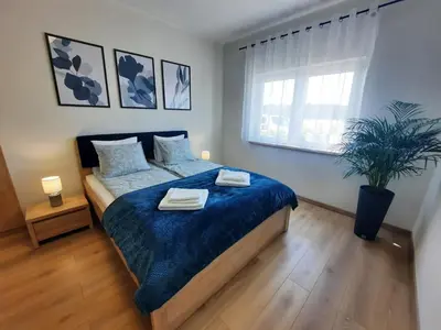 Łóżko lub łóżka w pokoju w obiekcie Chabrowa Apartamenty 1
