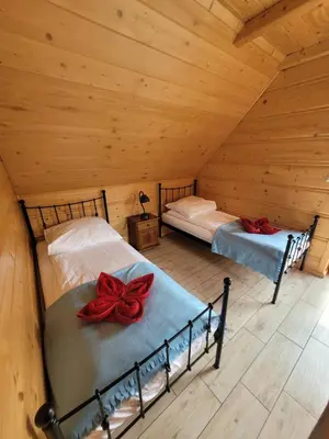 Łóżko lub łóżka w pokoju w obiekcie Osada Stasiowe Chaty