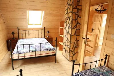 Łóżko lub łóżka w pokoju w obiekcie Osada Stasiowe Chaty