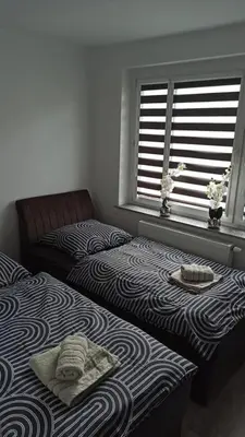 Łóżko lub łóżka w pokoju w obiekcie Apartament Zdrojowy II