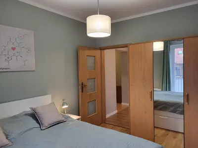 Łóżko lub łóżka w pokoju w obiekcie Sunny Apartment - Bliżej Zdroju