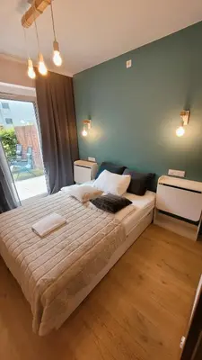 Łóżko lub łóżka w pokoju w obiekcie Green Terrace Family Apartment
