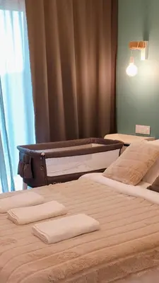 Łóżko lub łóżka w pokoju w obiekcie Green Terrace Family Apartment